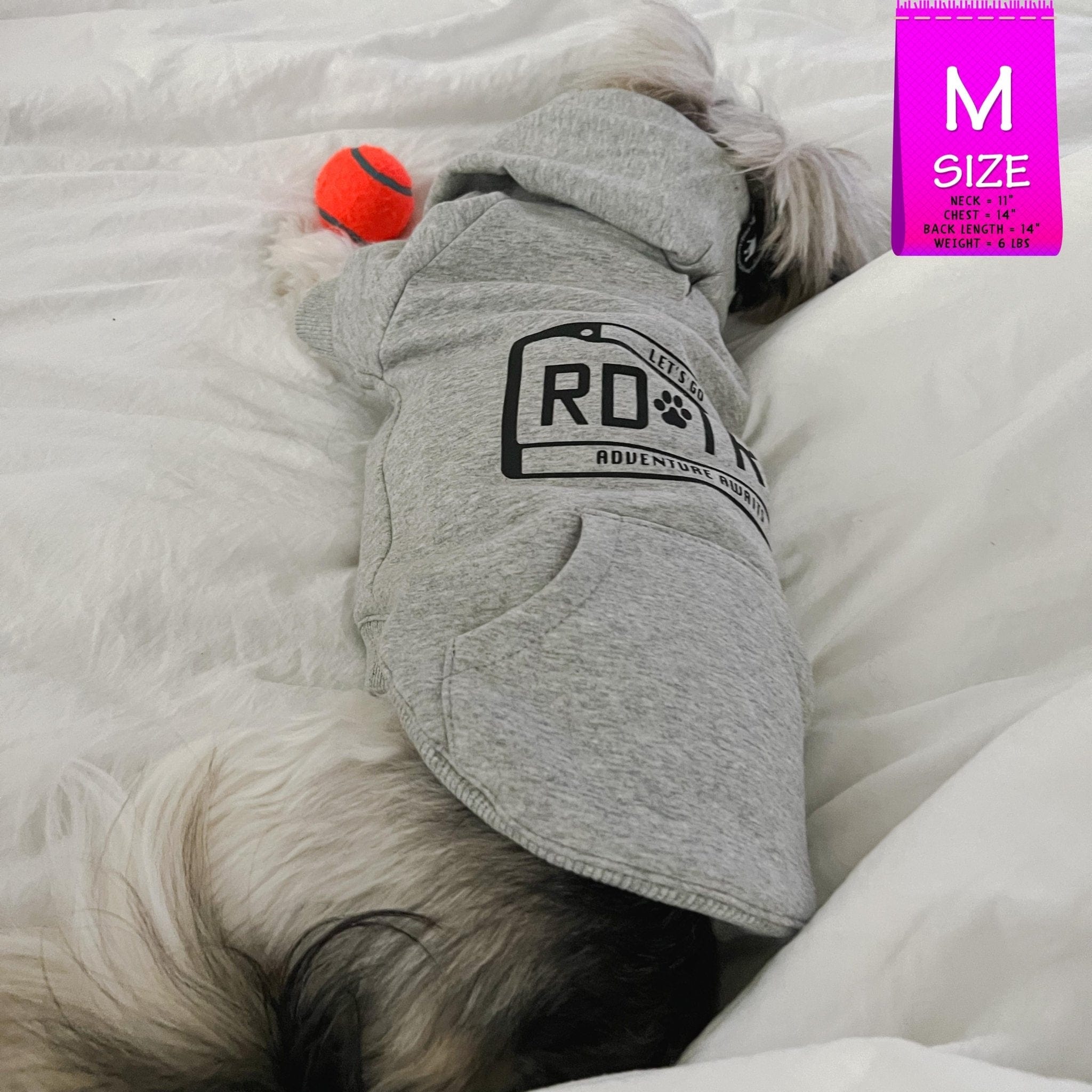 Hooded Sweatshirt For Dogs - Shih Tzu mix wearing "Road Trip" Hooded Sweatshirt with License Plate design in gray - back view - laying on the bed sleeping with orange tennis ball toy - Wag Trendz