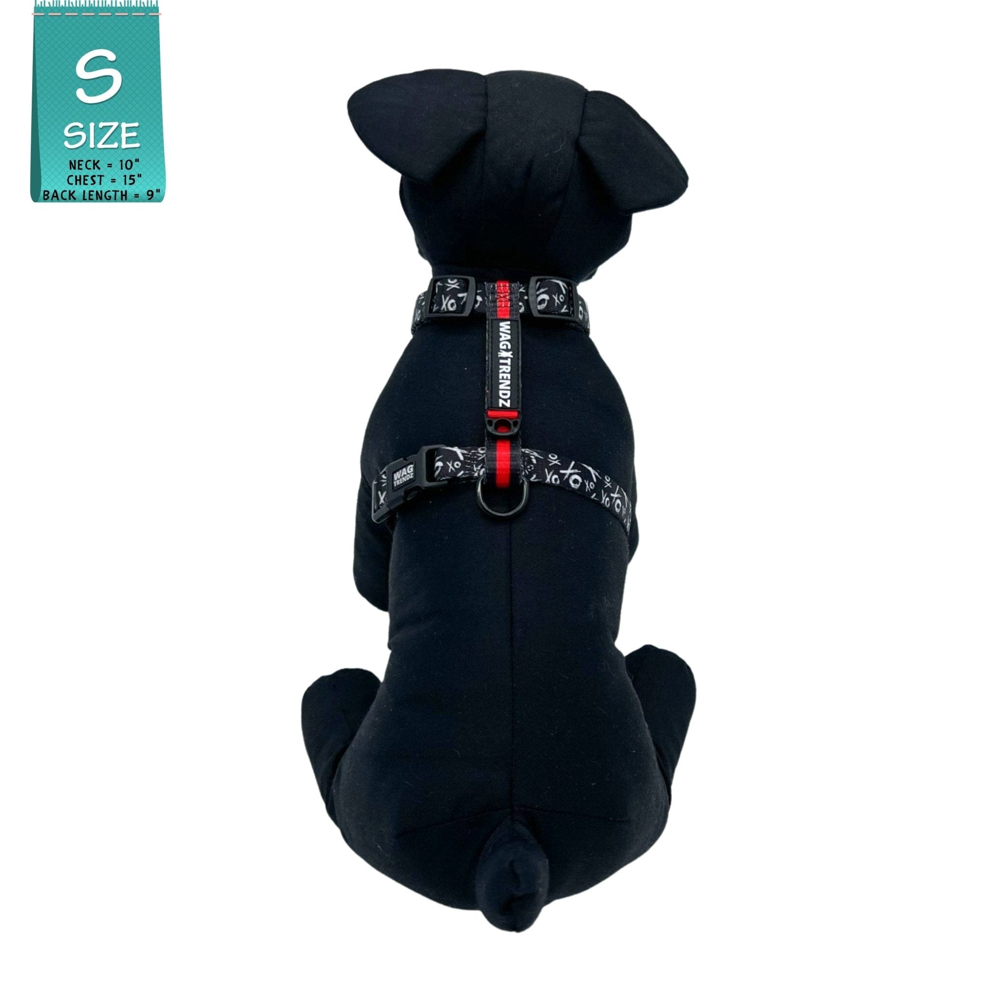 H Dog Harness - Roman Dog Harness - worn by black stuffed dog wearing black and white XO pattern with red accents - against a solid white background - Wag Trendz