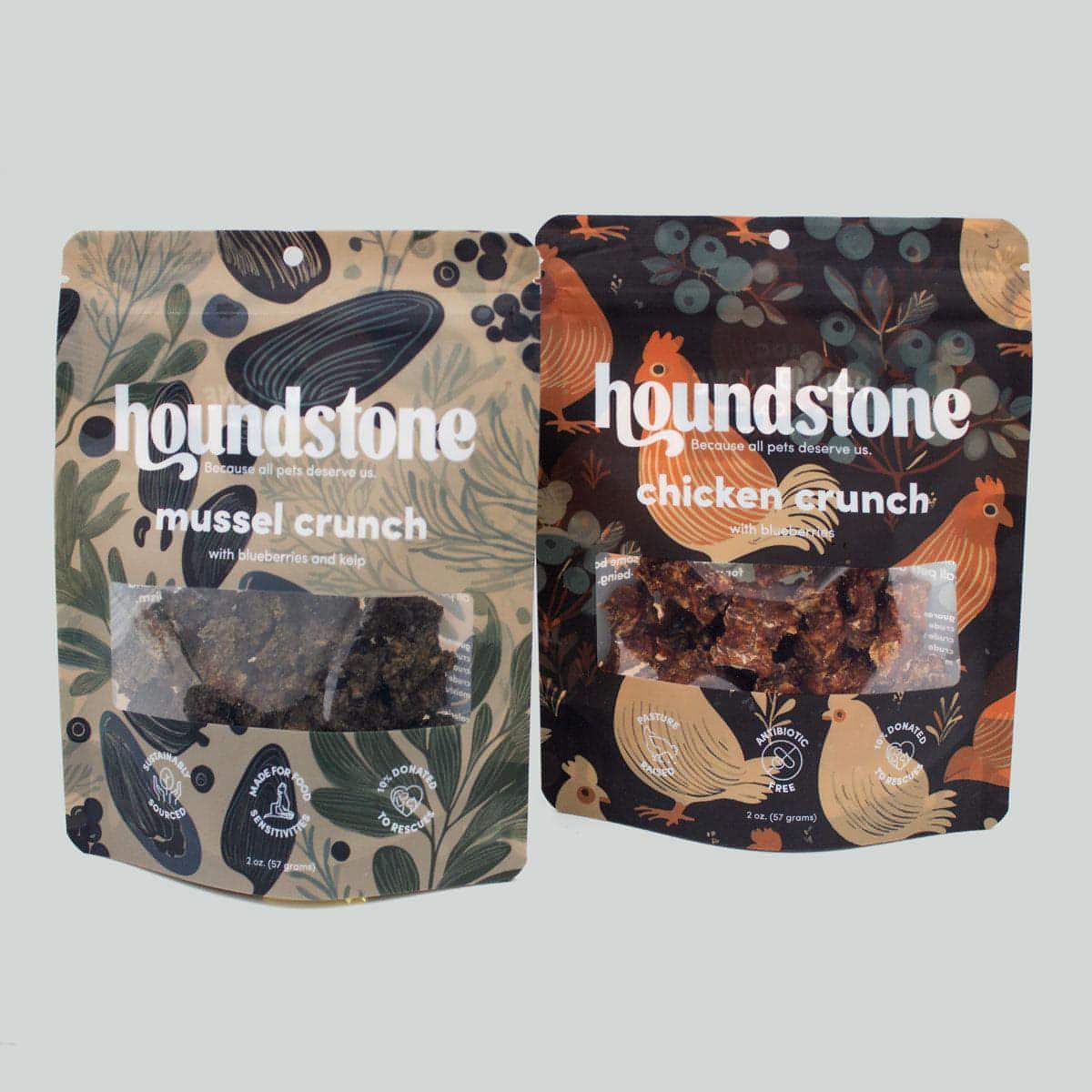 Two packages of houndstone dehydrated dog treats, one labeled 'mussel crunch' and the other 'chicken crunch', on a light gray background.