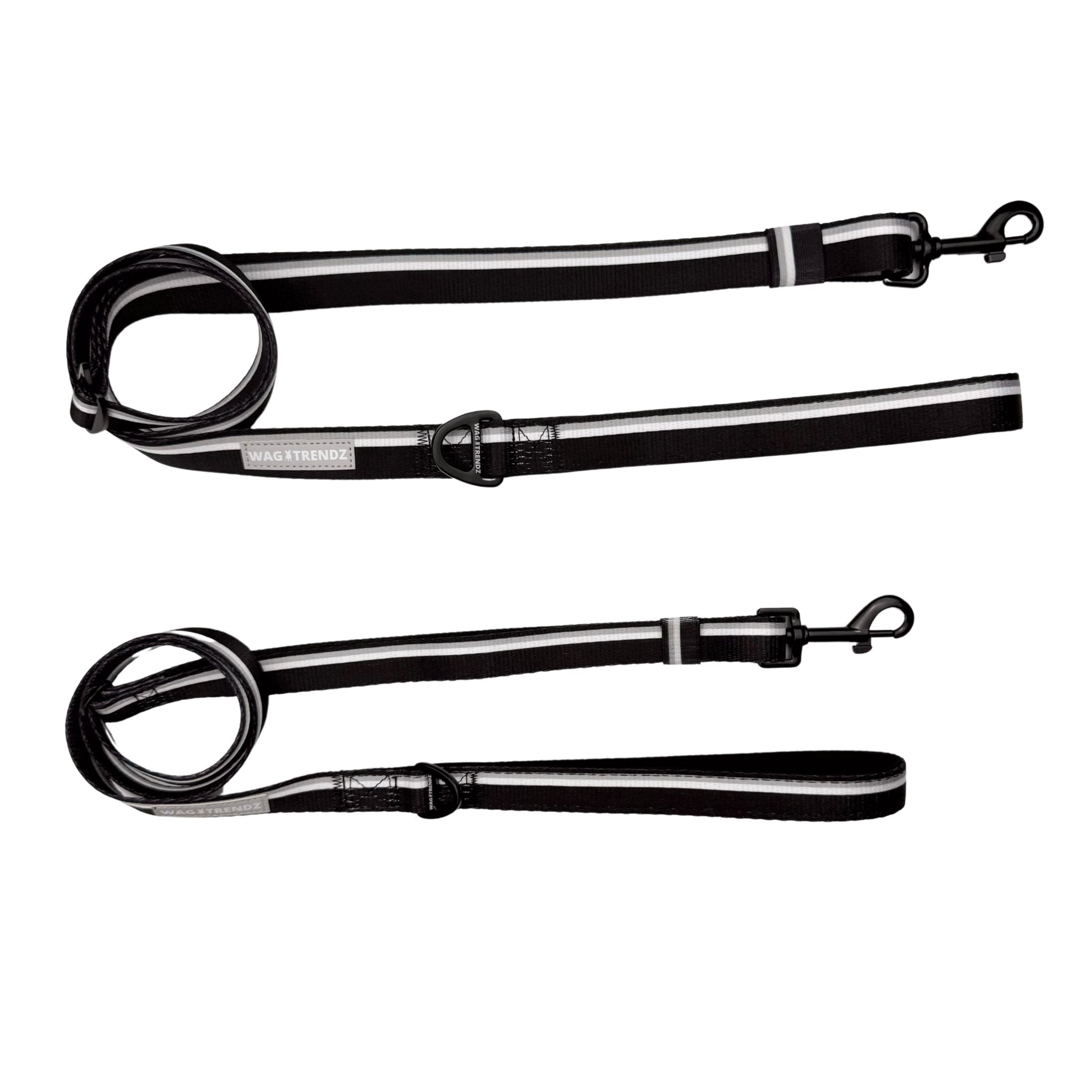Two black adjustable dog leashes with metal clips on a white background